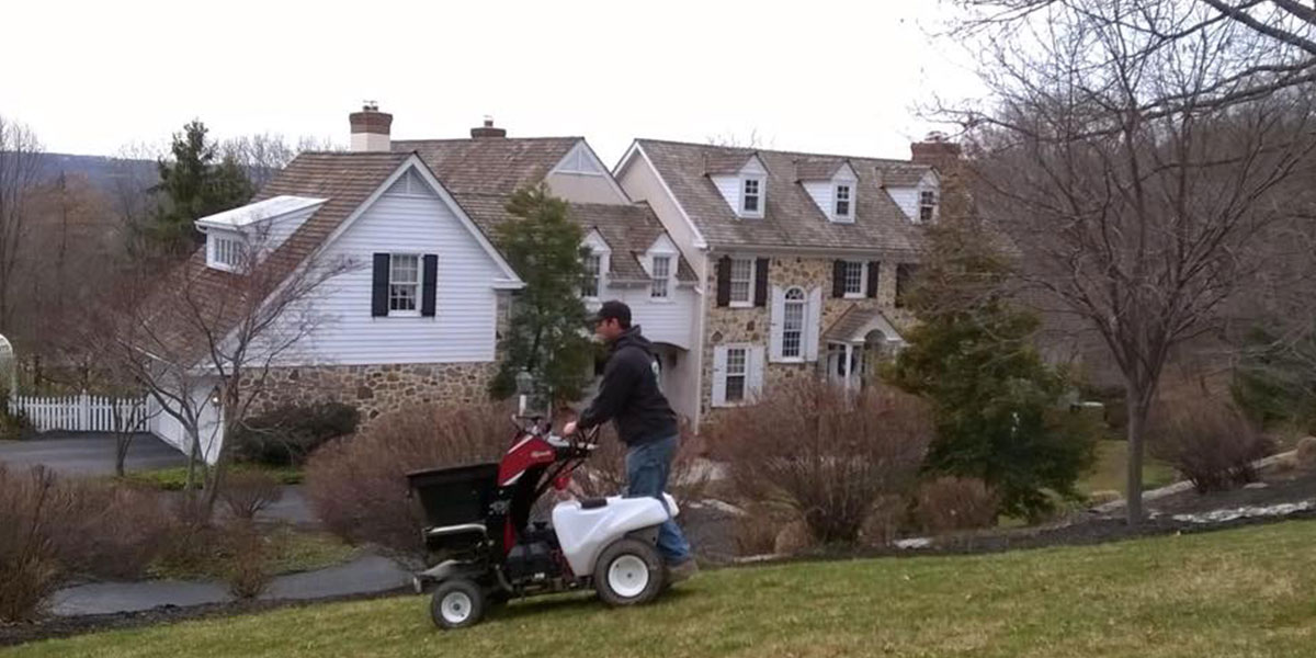 man with lawn fertilizer machine
